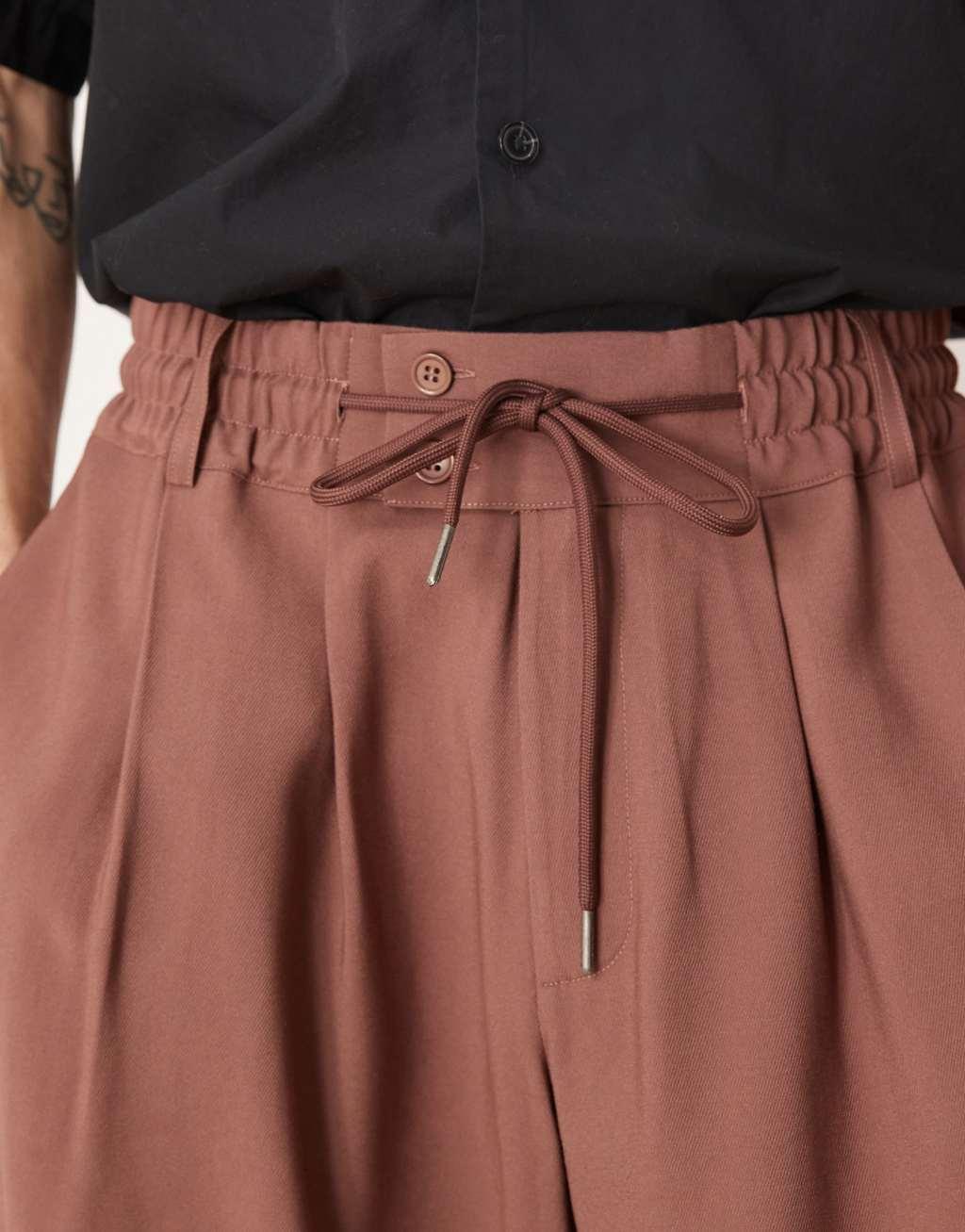 ASOS DESIGN loose fit smart pants with wide waistband and elasticated waist in brown Product Image