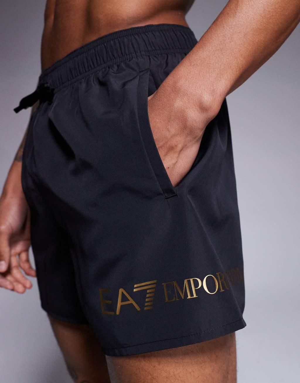 Armani EA7 gold logo swim shorts in black Product Image