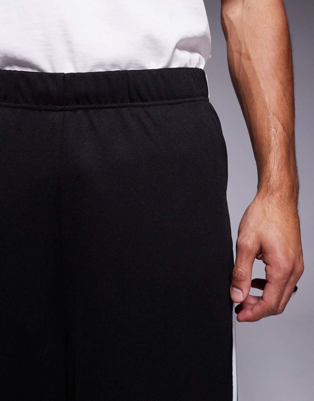 ASOS DESIGN baggy balloon sweatpants with side tape in black Product Image
