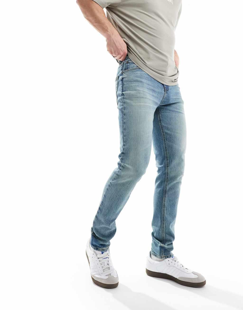 ASOS DESIGN skinny jeans in a tinted vintage mid wash Product Image