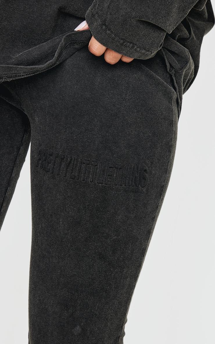 PRETTYLITTLETHING Black Embossed Logo Washed Skinny Flare Pants Product Image
