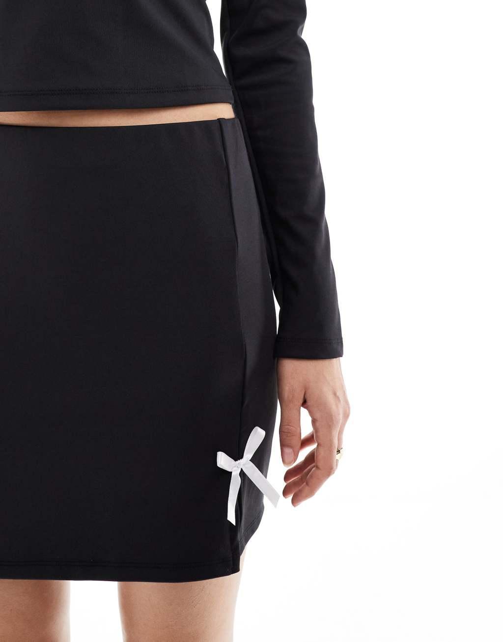 Pieces Mix & Match slinky mini skirt with pink bow front in black - part of a set Product Image
