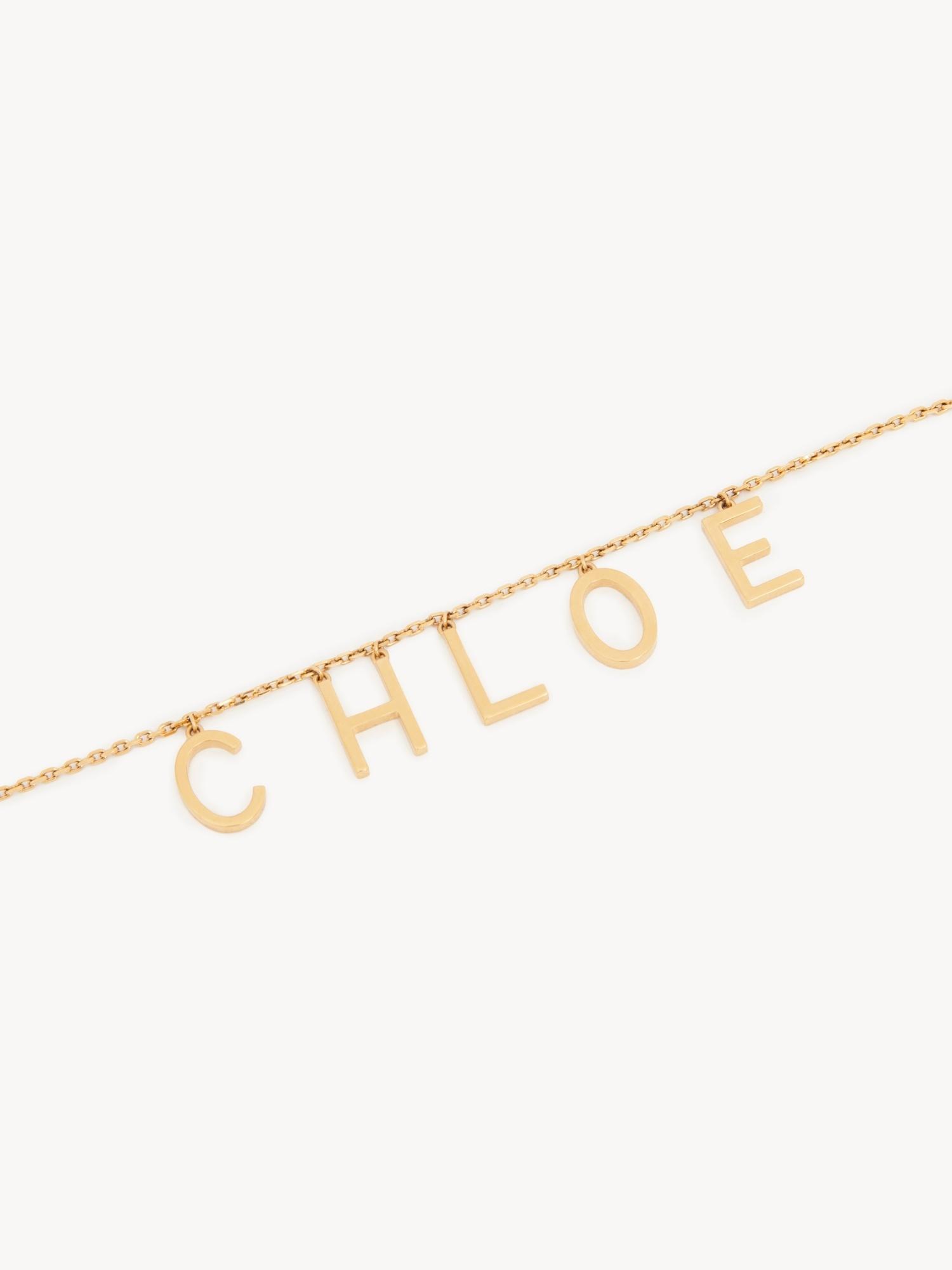 CHLOÉ Metallic Belt With Adjustable Hook Closure And Logo Lettering Charm In Brass Woman In Gold Product Image