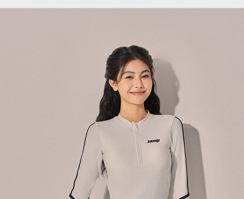 Set: Long-Sleeve Lettering Striped Rash Guard + Contrast Trim Swim Shorts Product Image
