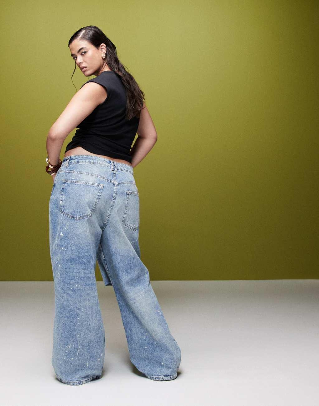 ASOS DESIGN Curve baggy jeans with rips and paint splats in mid blue Product Image