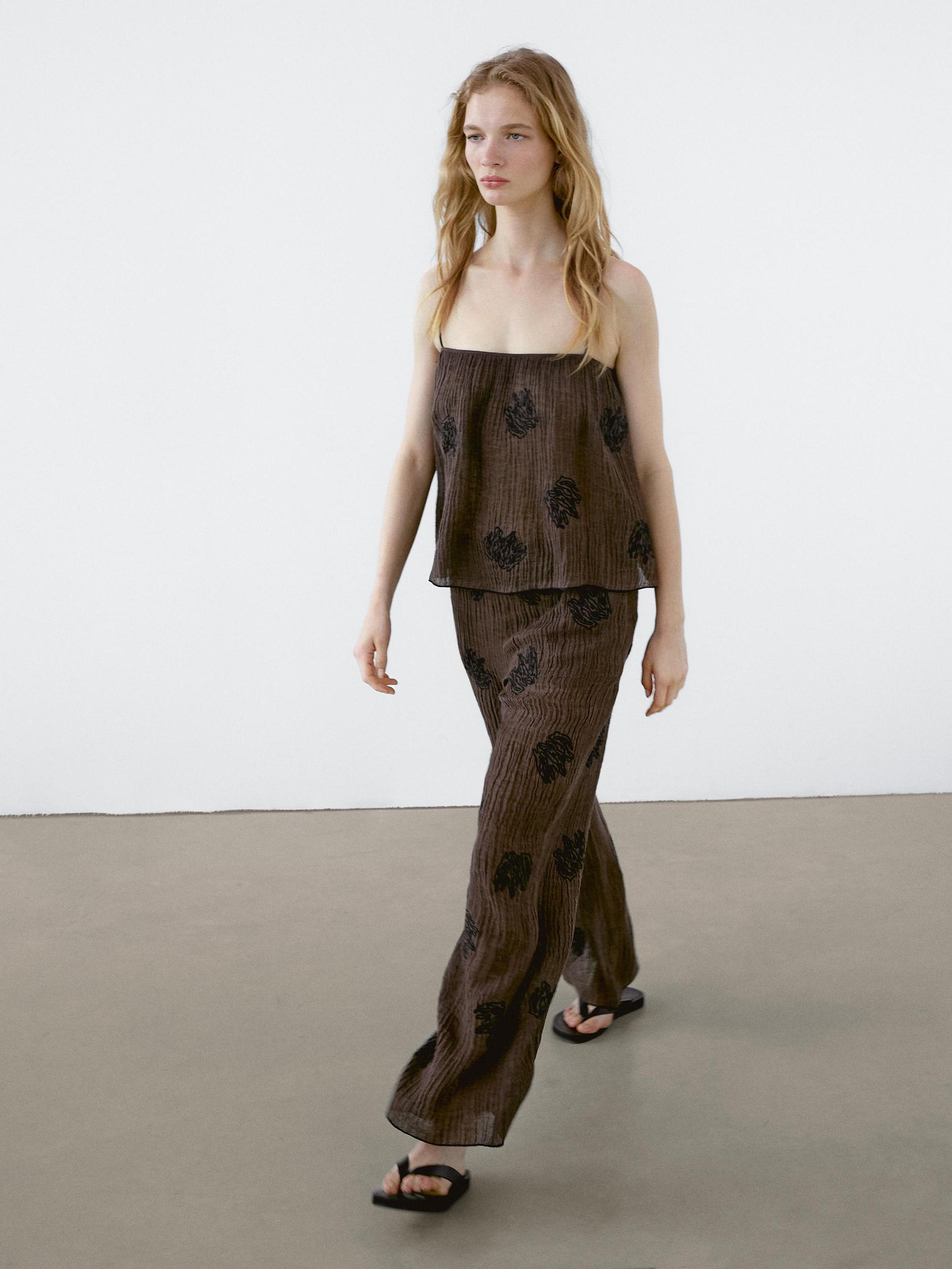 Flowing textured trousers with embroidered detail Product Image