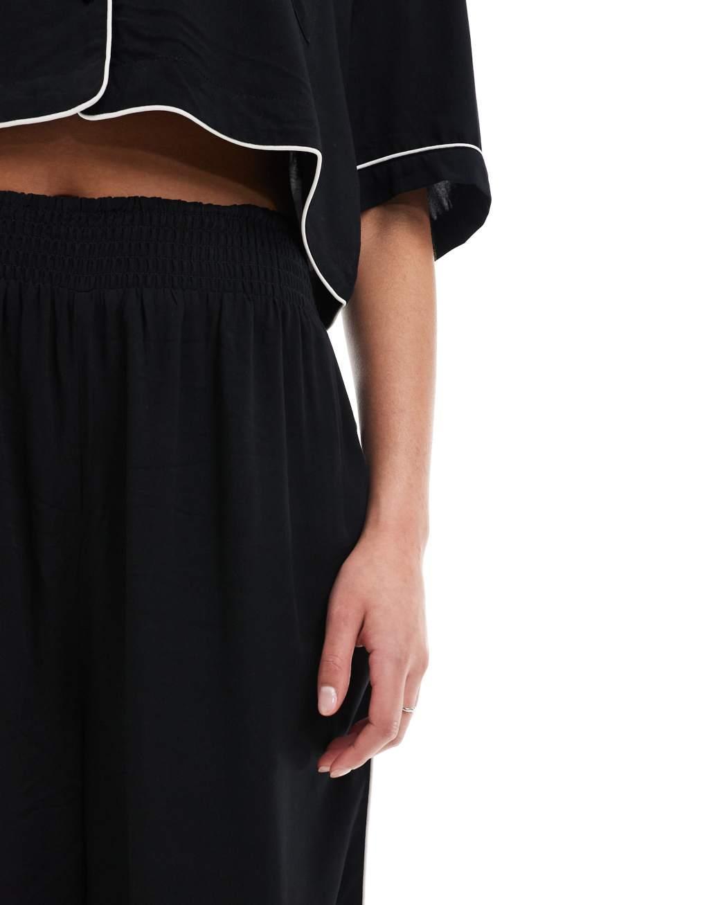 ASOS DESIGN Tall super soft slinky wide leg pajama pants in black with contrast binding Product Image