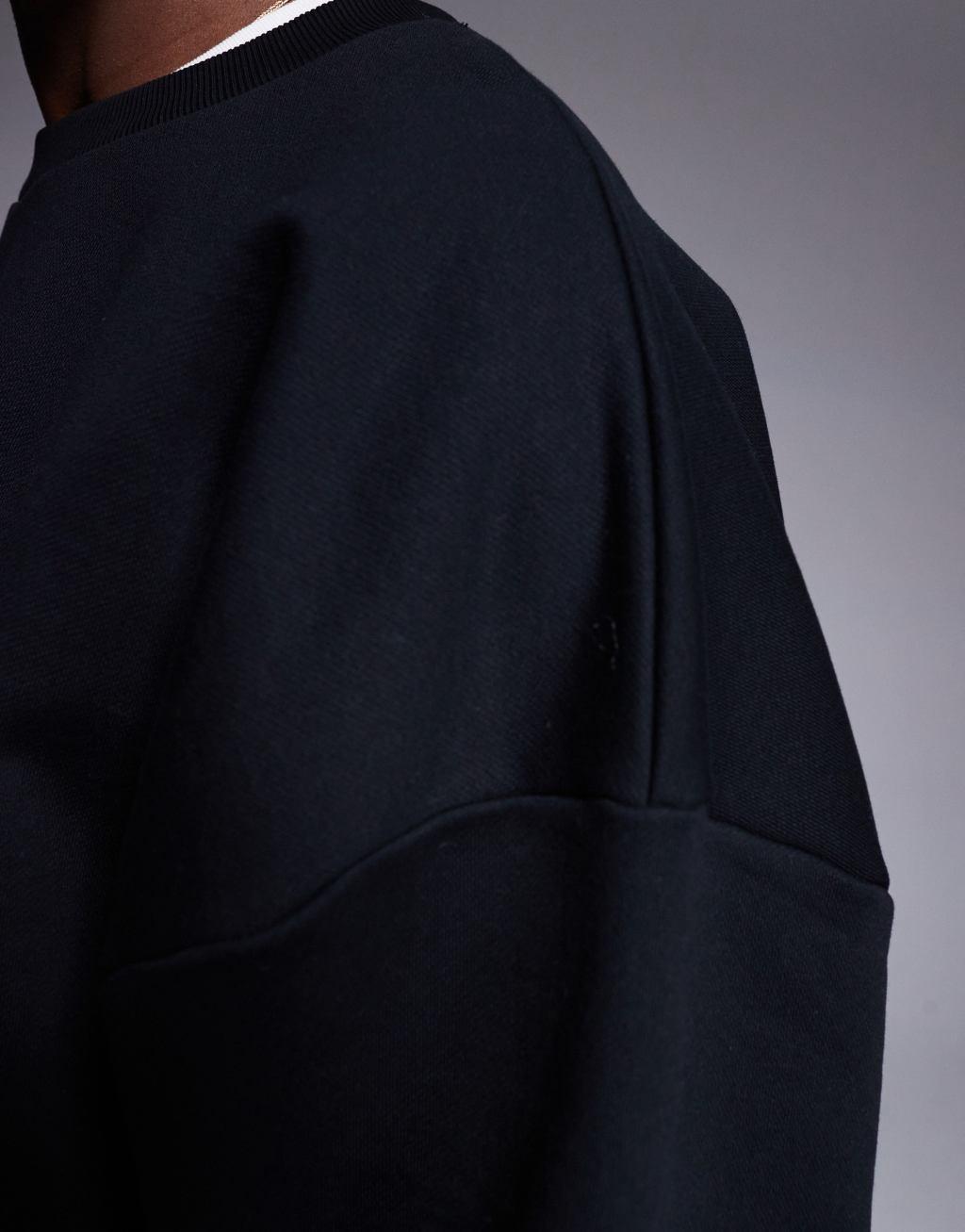ASOS DESIGN heavyweight boxy extreme oversized sweatshirt with elasticized cuffs and hem in black Product Image