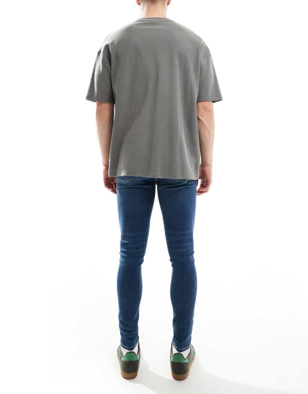 ASOS DESIGN power stretch jeans in dark wash blue Product Image