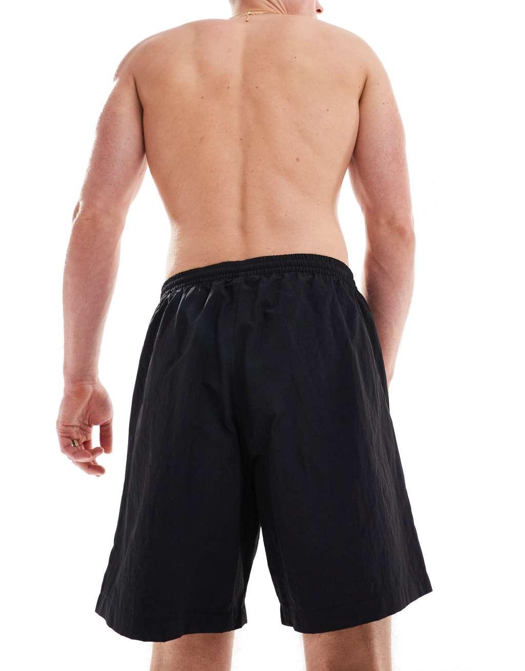 Weekday Ed skater style swim shorts in black Product Image