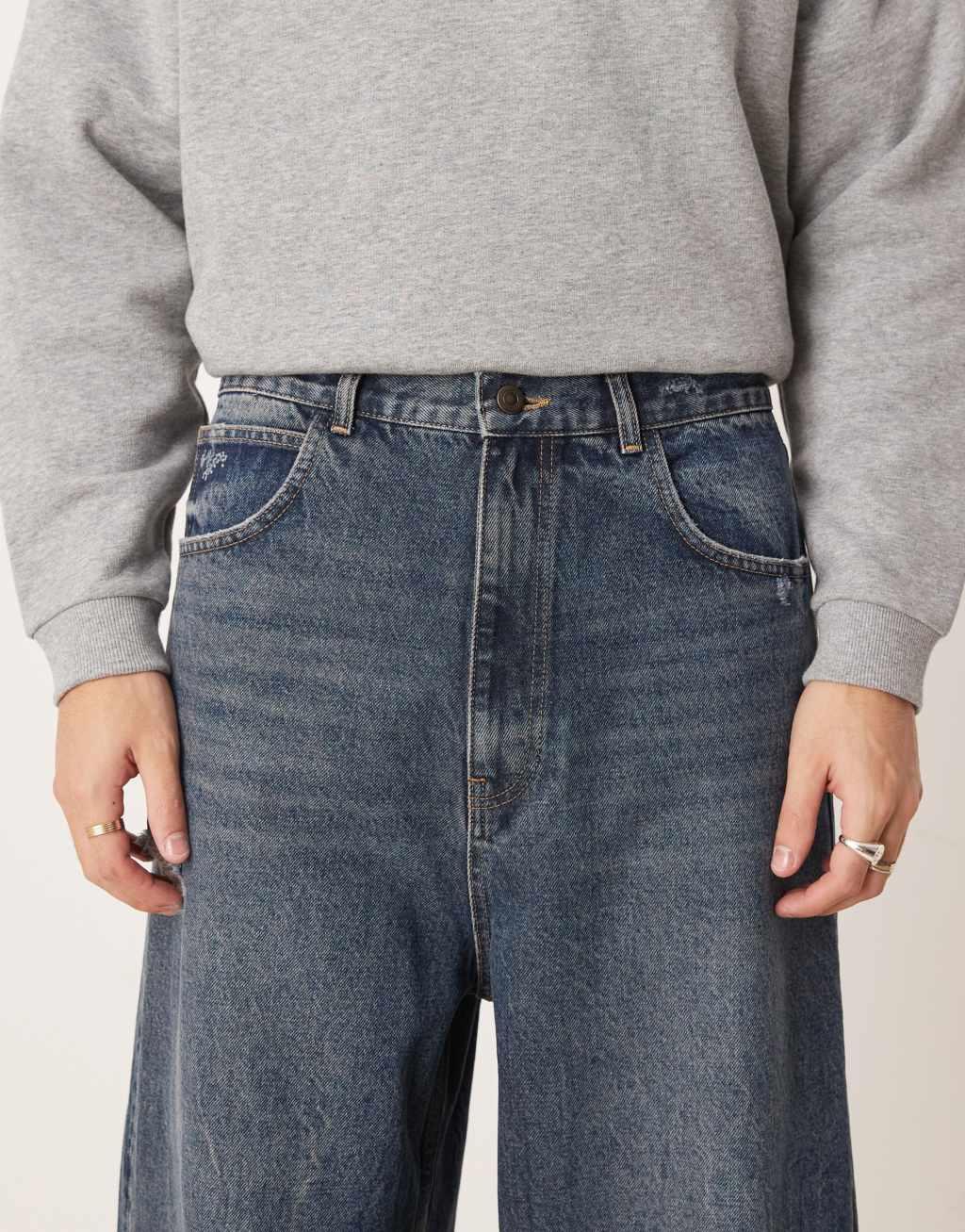 ASOS DESIGN skater fit jeans in dark wash blue with rips Product Image