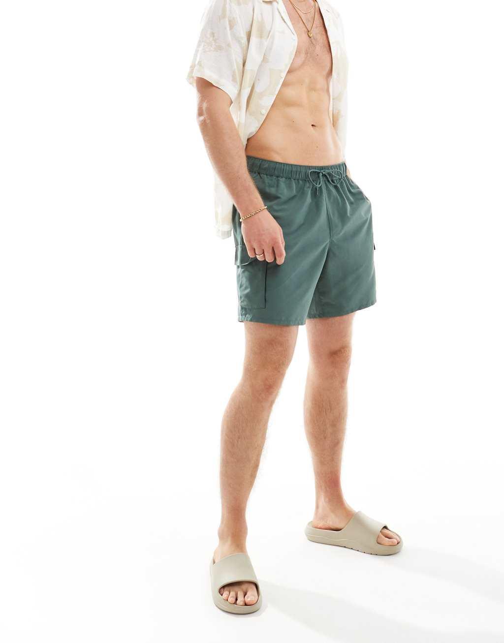 ASOS DESIGN swim shorts in mid length with cargo pockets in khaki Product Image
