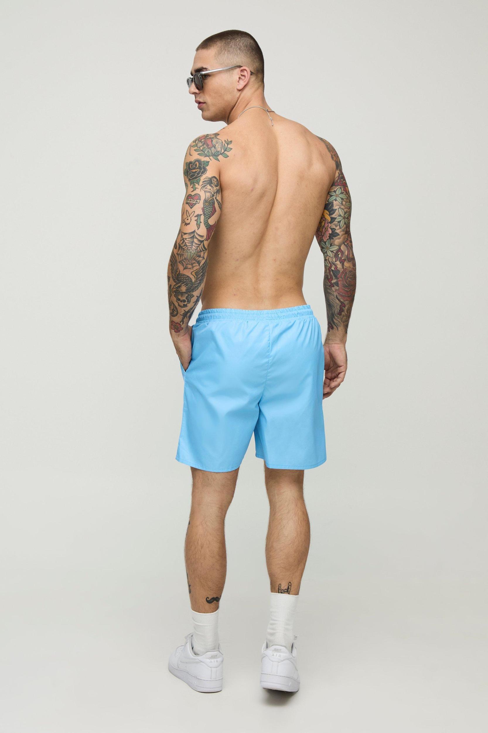 2 Pack Wide Stripe and Plain Mid Length Swim Trunks | boohooMAN USA Product Image