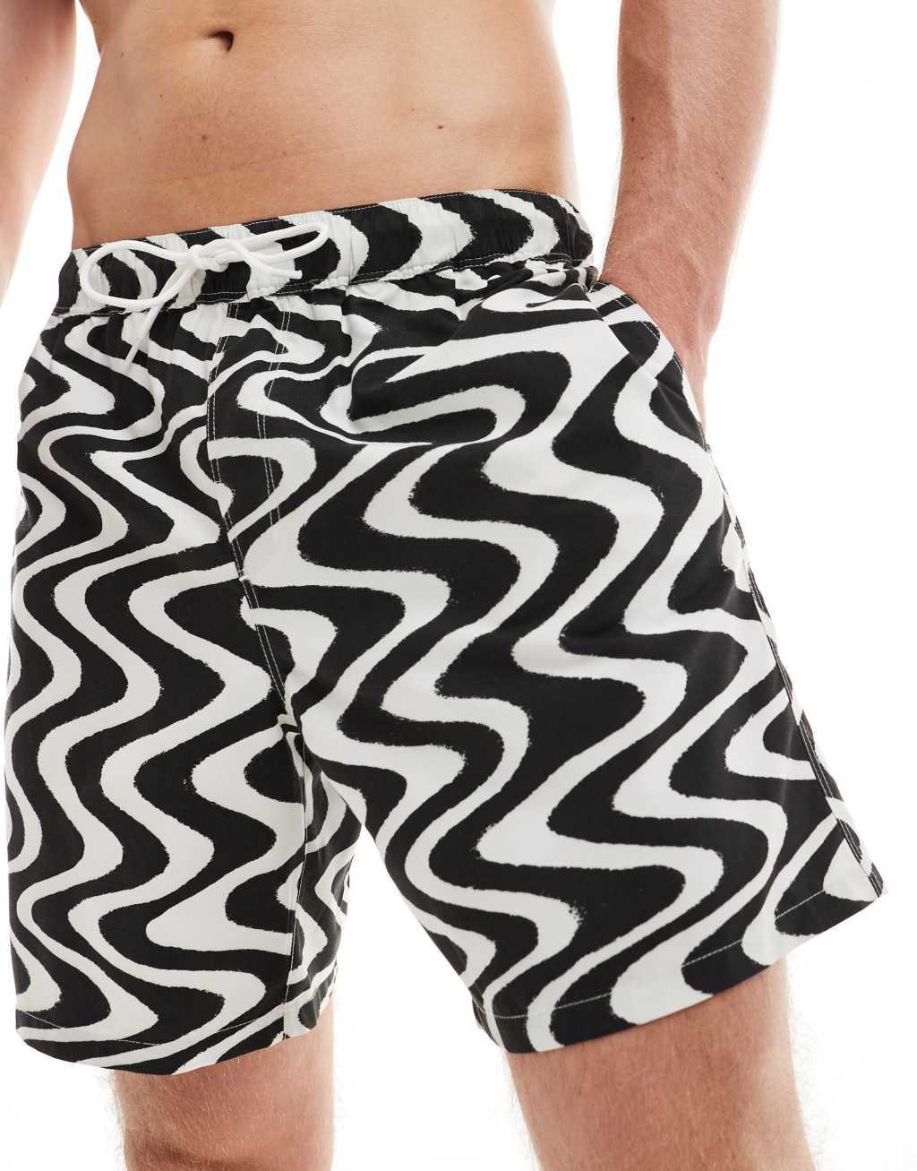 ASOS DESIGN swim shorts in mid length in black wave print Product Image