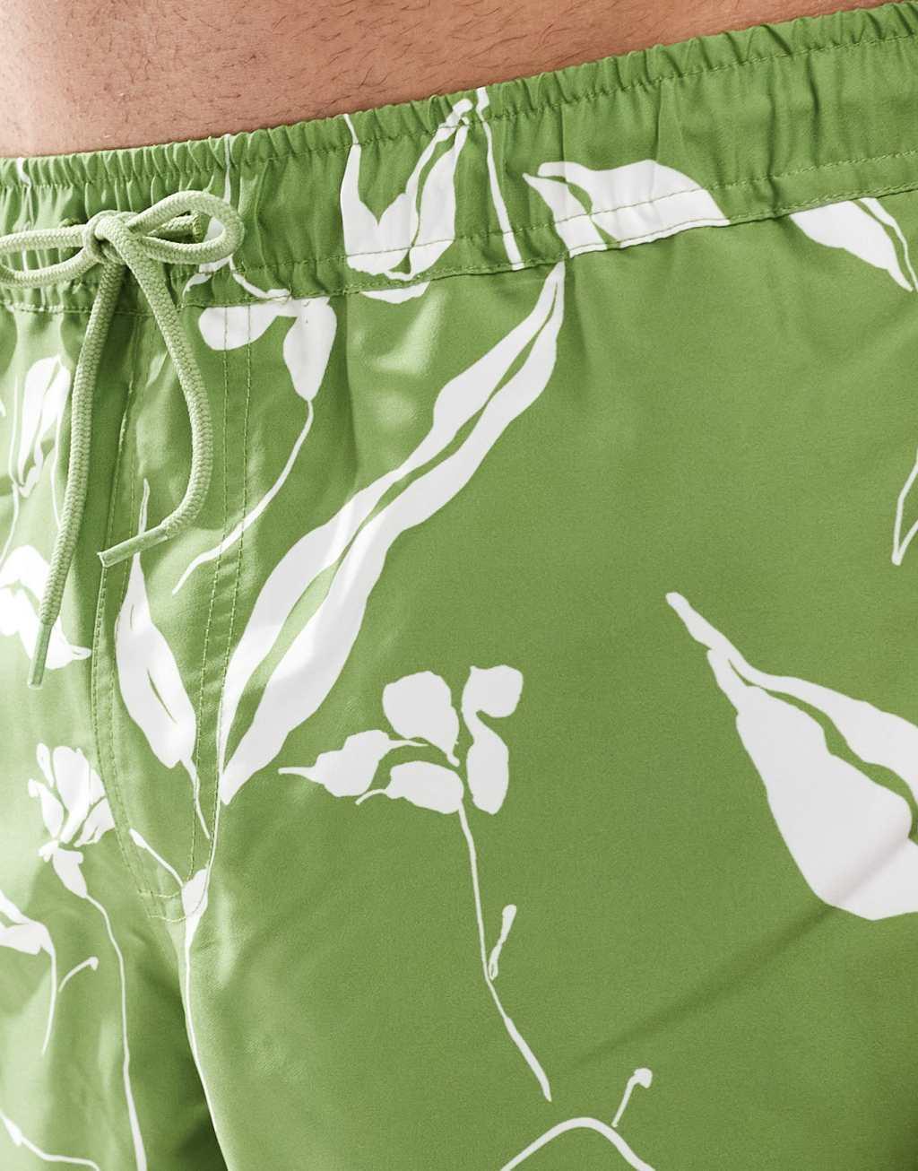ASOS DESIGN swim shorts in short length in green floral print Product Image