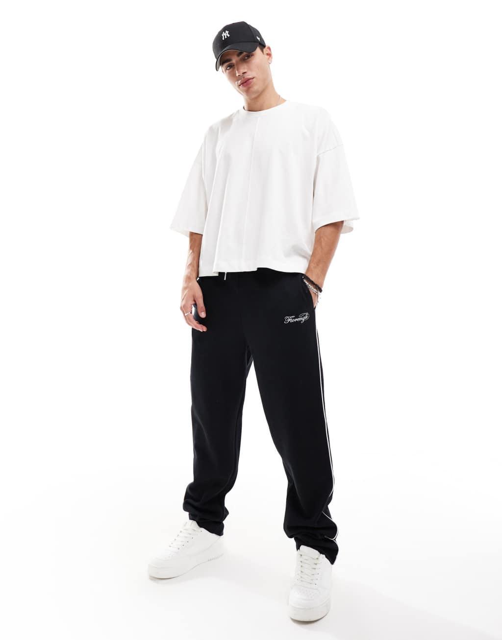ASOS DESIGN straight leg sweatpants with embroidery and tipping details in black Product Image