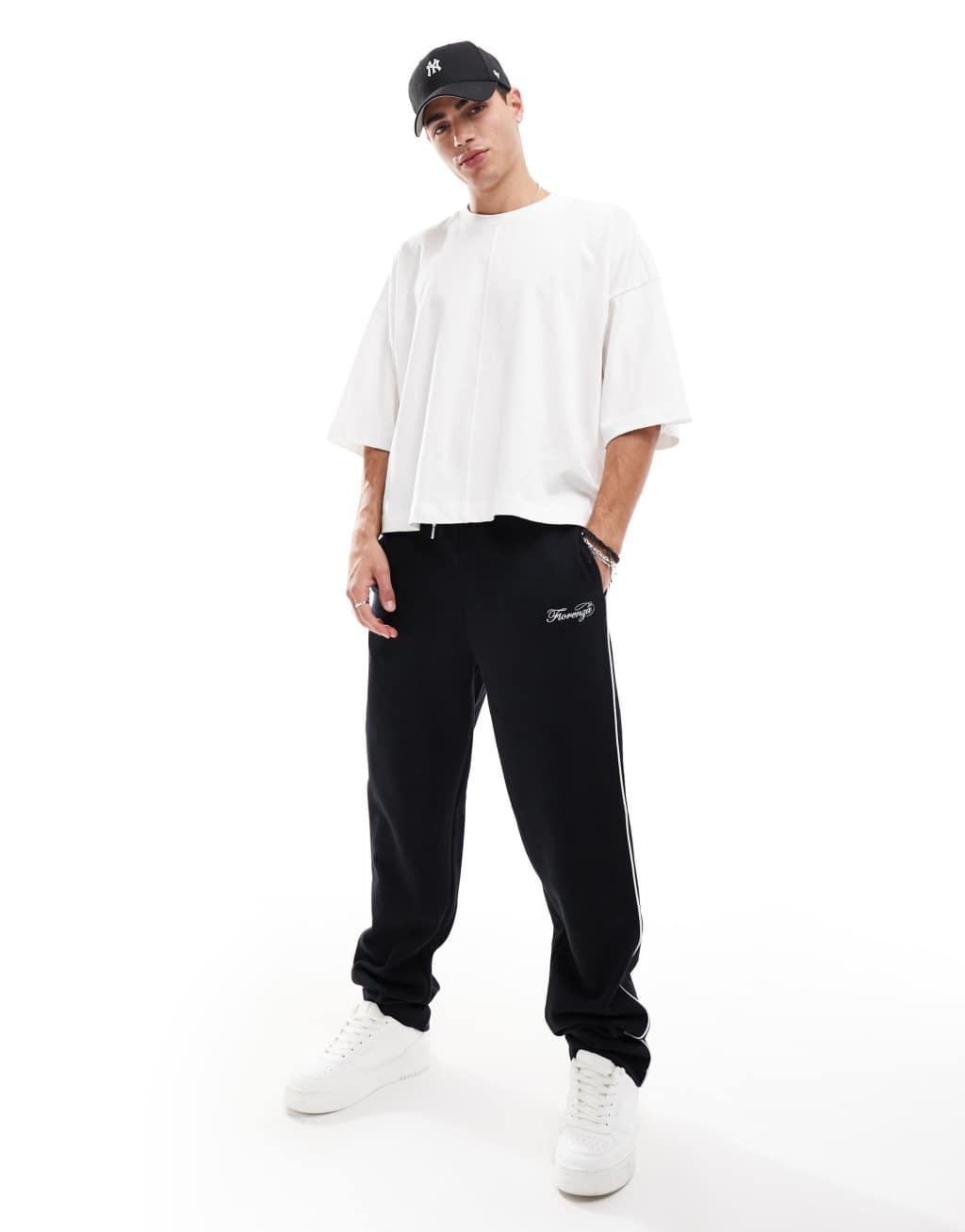 ASOS DESIGN straight leg sweatpants with embroidery and tipping details in black Product Image