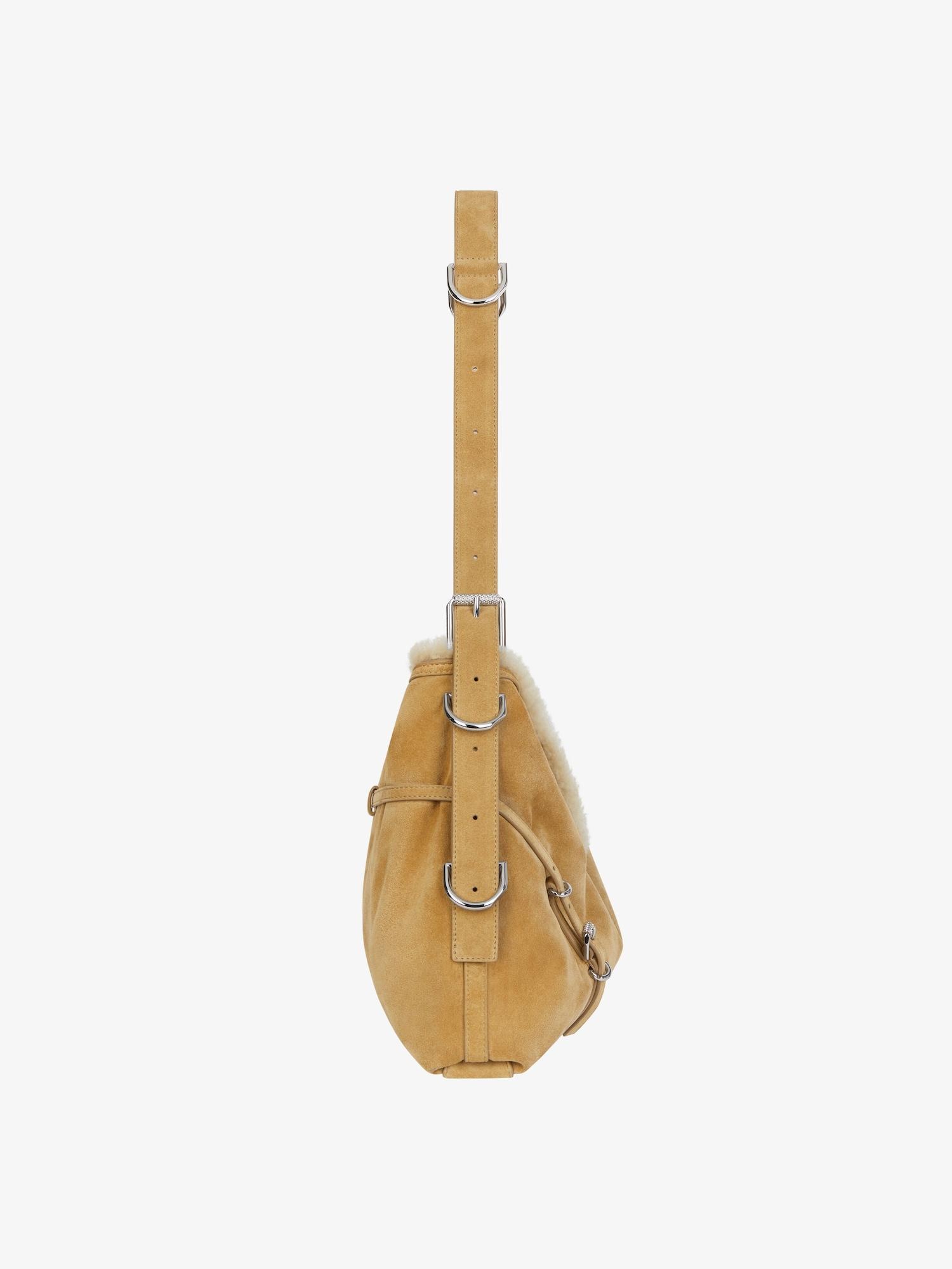 Medium Voyou bag in suede and shearling Product Image