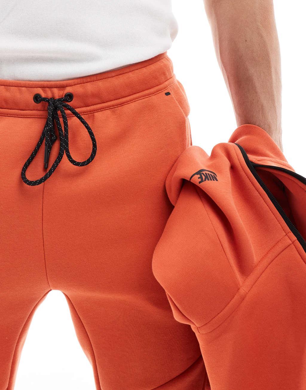 Nike Tech Fleece cuffed sweatpants in orange Product Image