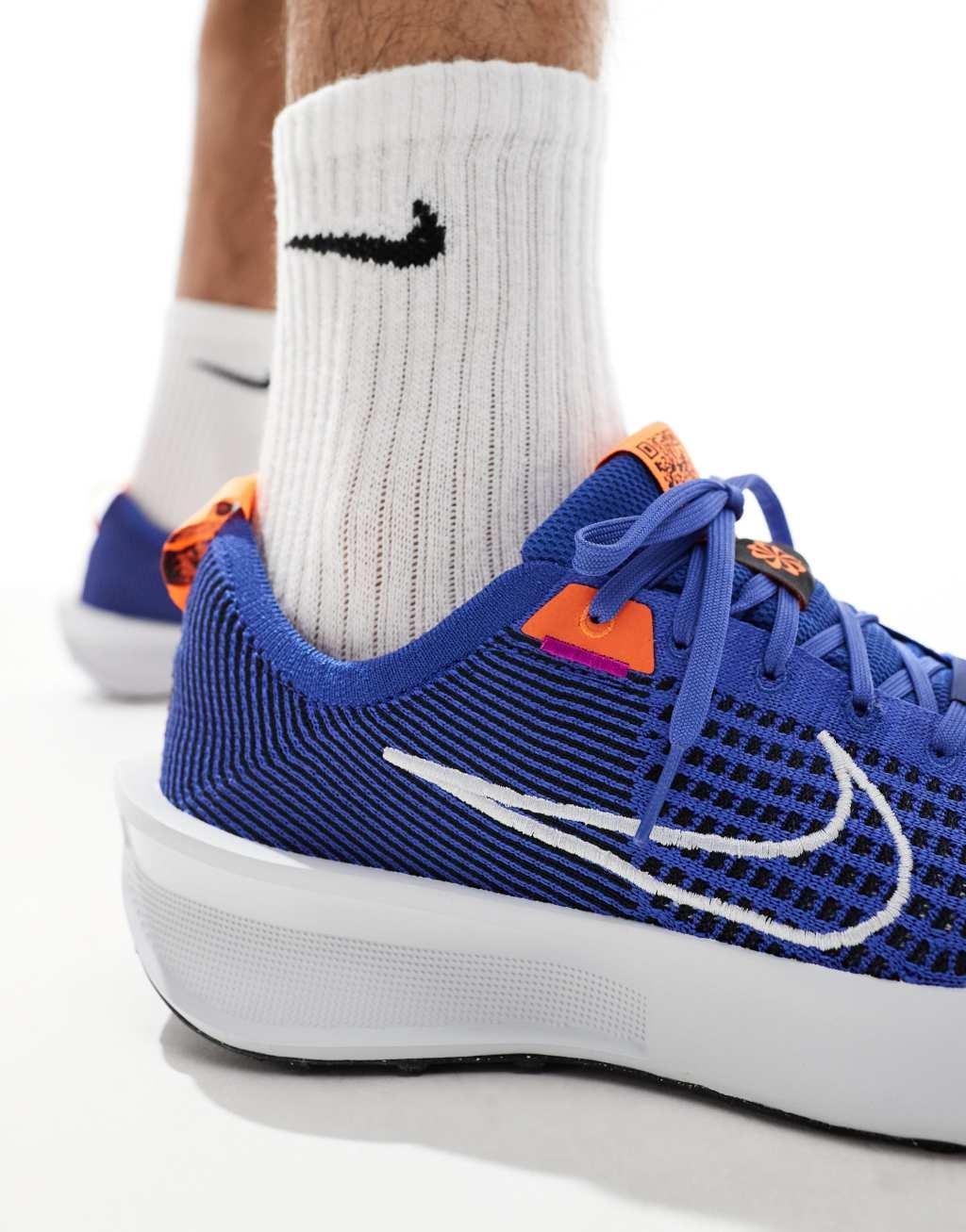 Nike Running Interact Run sneakers in blue and white Product Image