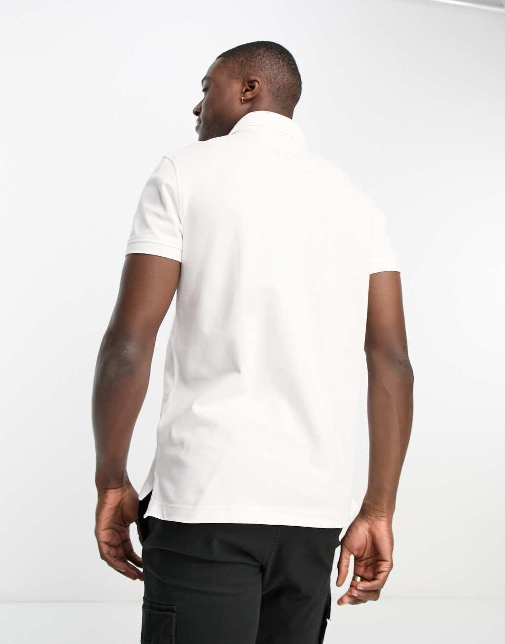 Tommy Hilfiger 1985 icon logo slim fit pique polo shirt in white Product Image