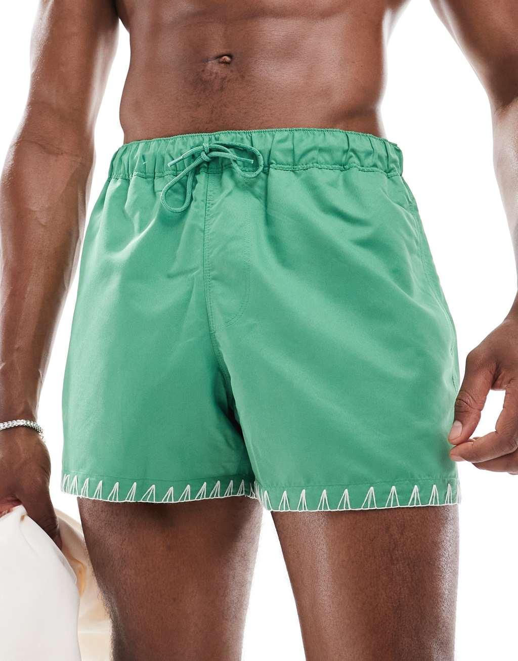 ASOS DESIGN swim shorts in short length in green with hem detail Product Image