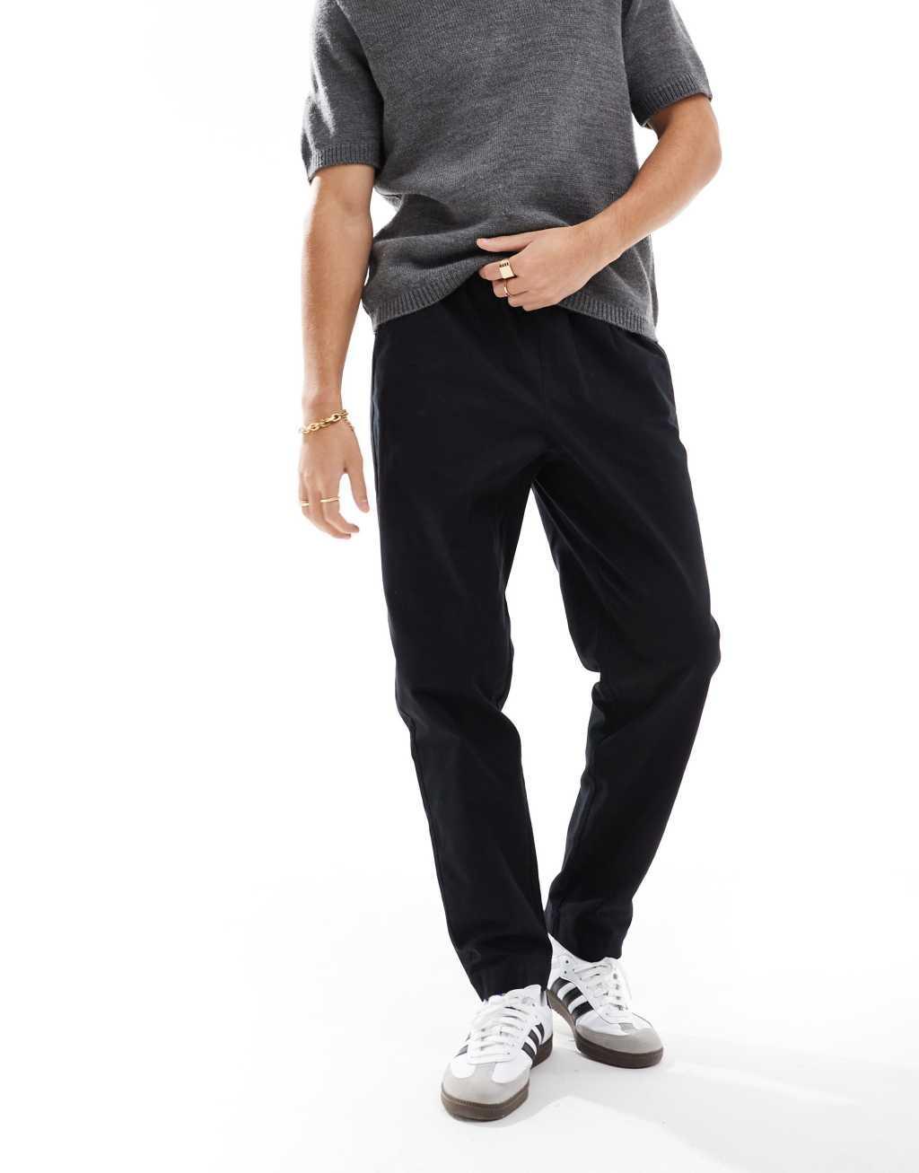 ASOS DESIGN tapered pull on pants in black with patch Product Image
