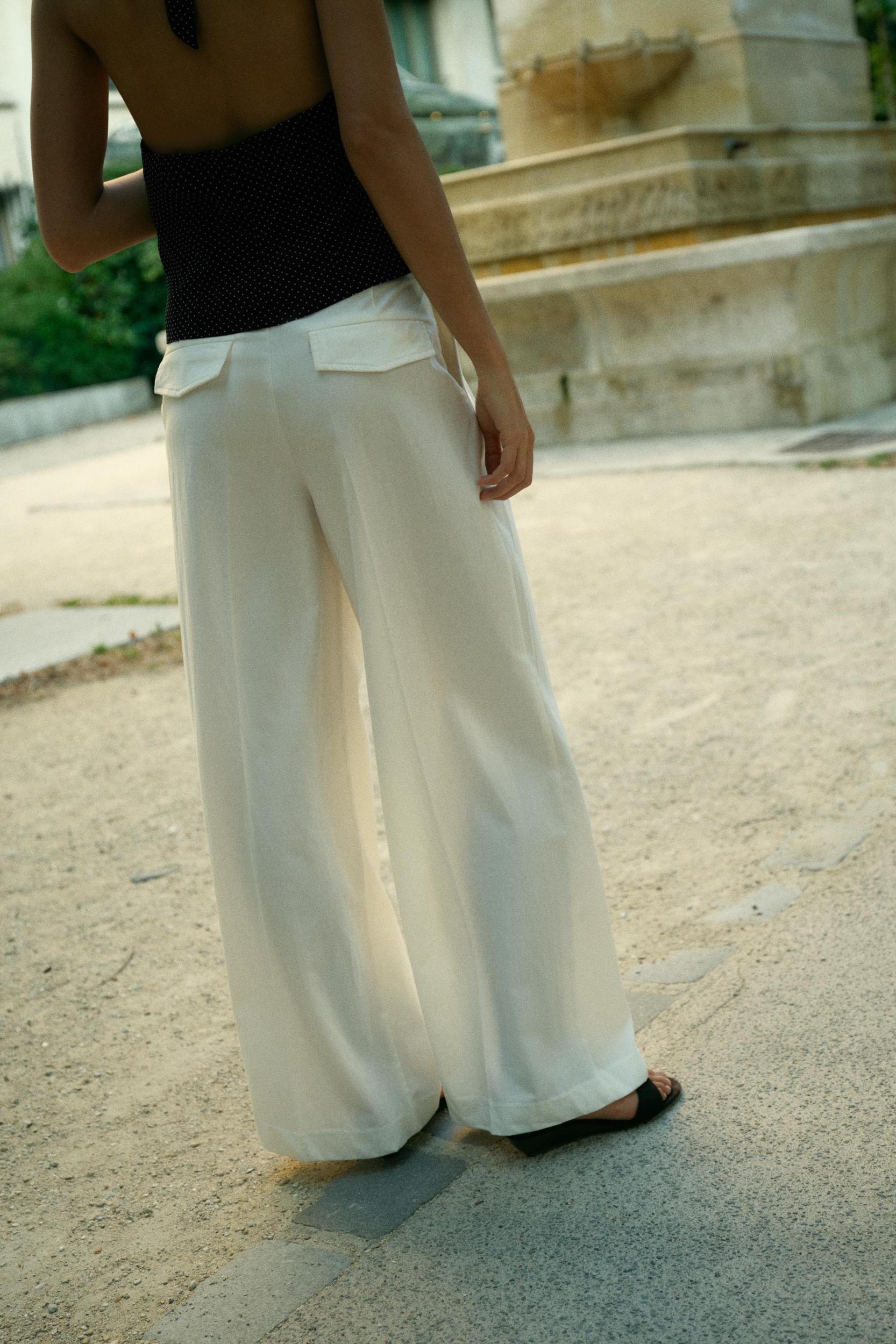 PLEATED PANTS WITH FLAPS Product Image