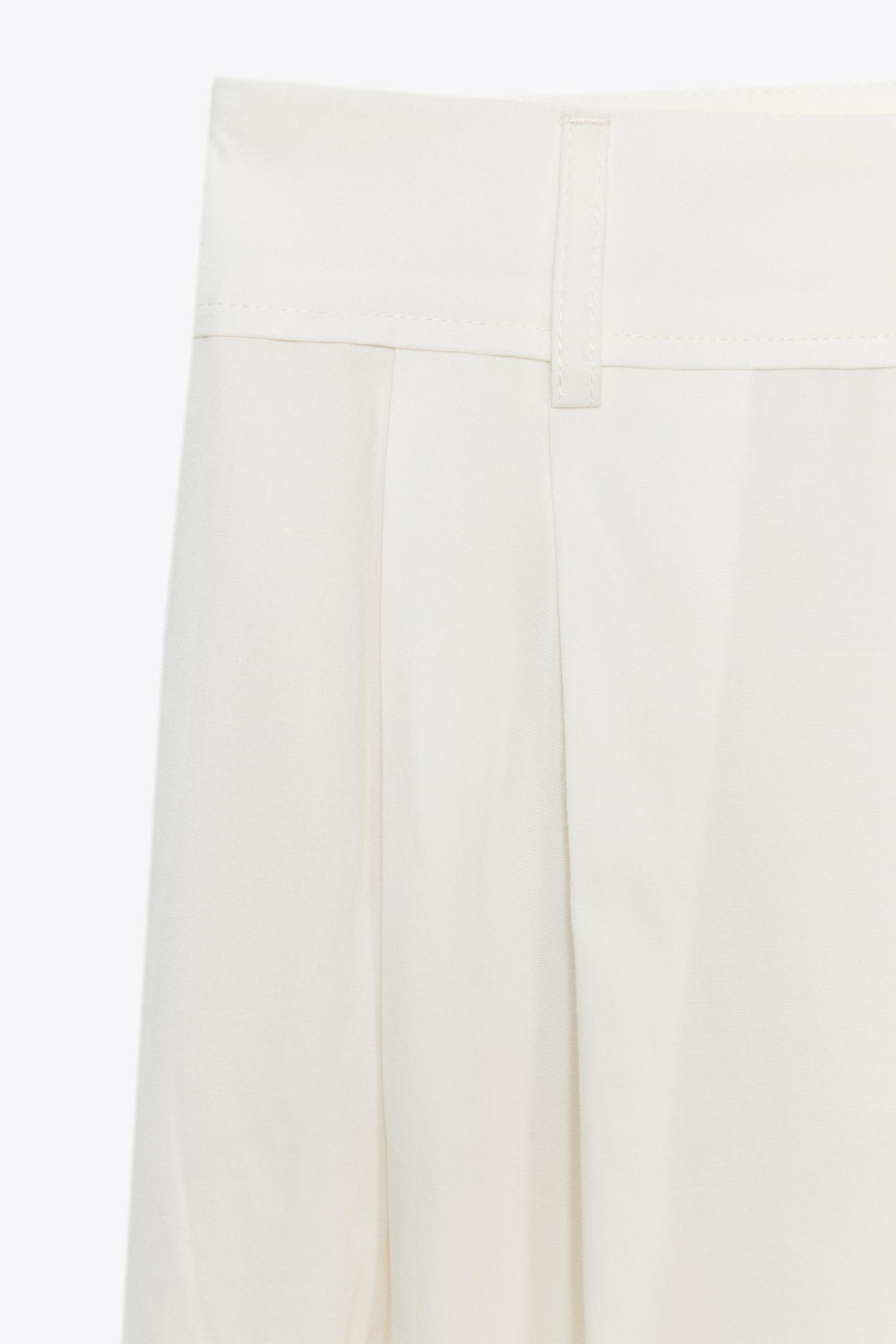 PLEATED PANTS WITH FLAPS Product Image