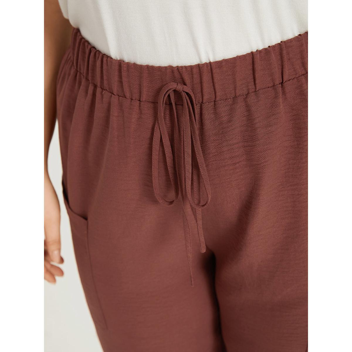 Plus Size Solid Patched Pocket Bowknot Button Detail Pants Women Rust Casual High Rise Dailywear Pants BloomChic 26/4X Product Image