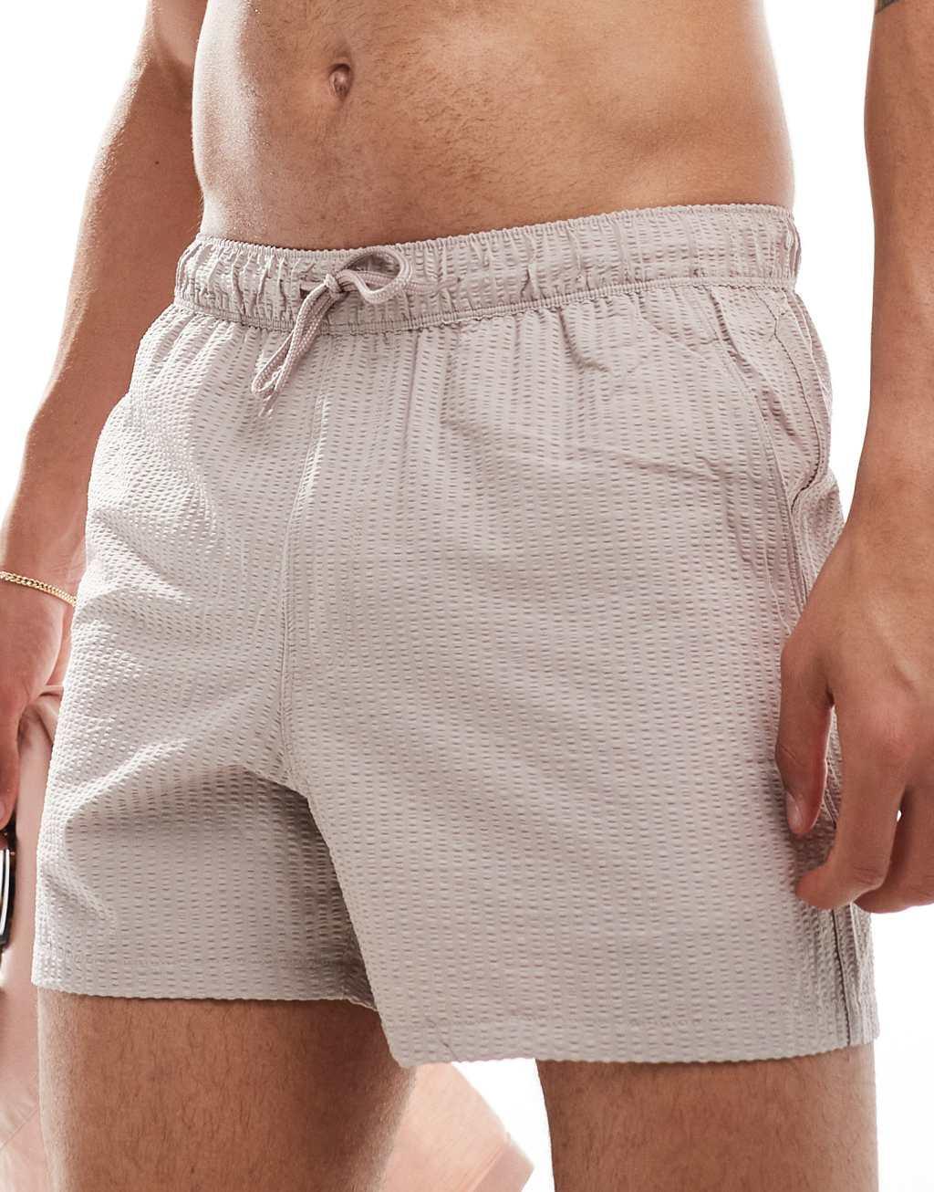 ASOS DESIGN swim shorts in short length with pocket detail in pink  Product Image