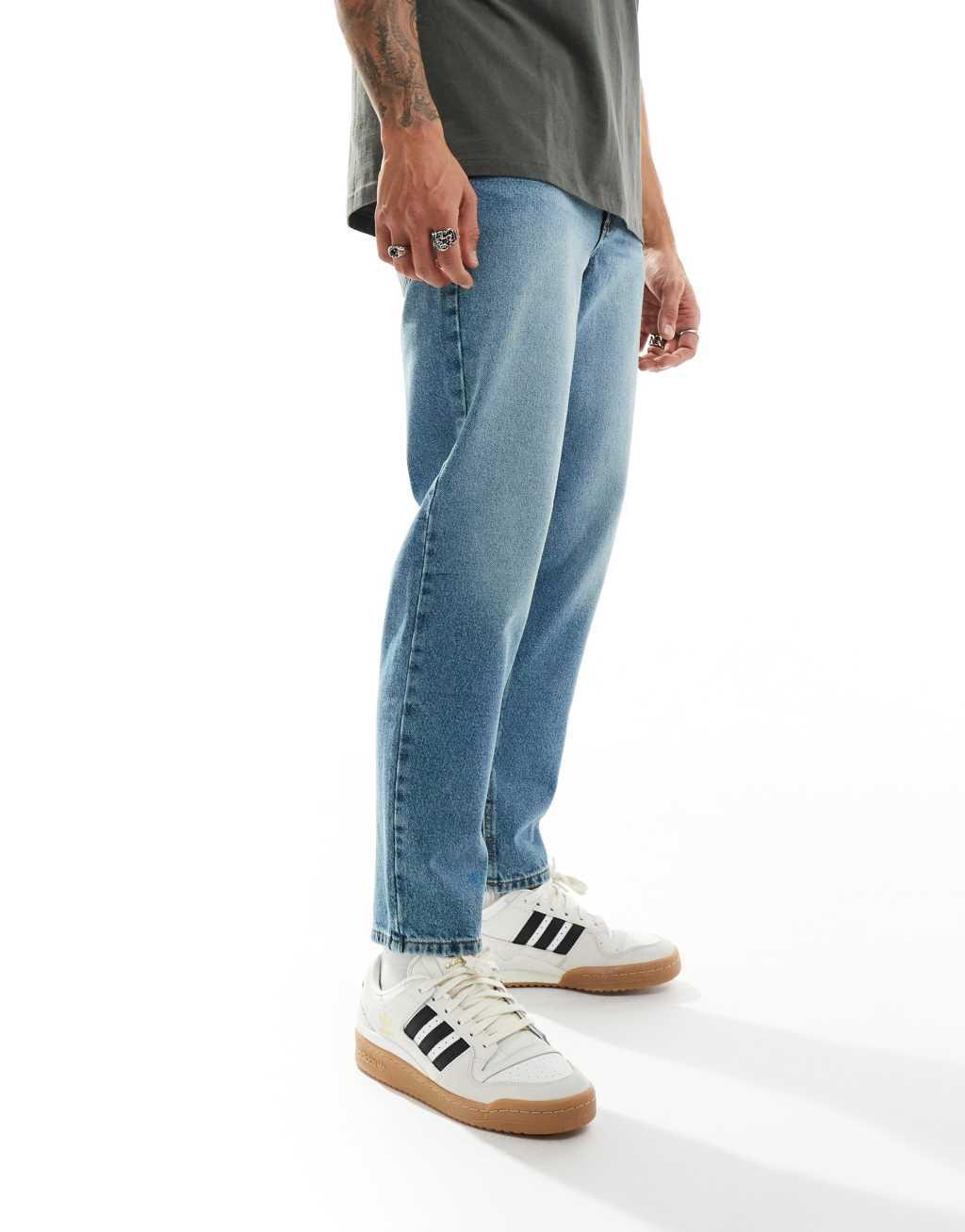 ASOS DESIGN tapered jeans in mid wash blue Product Image