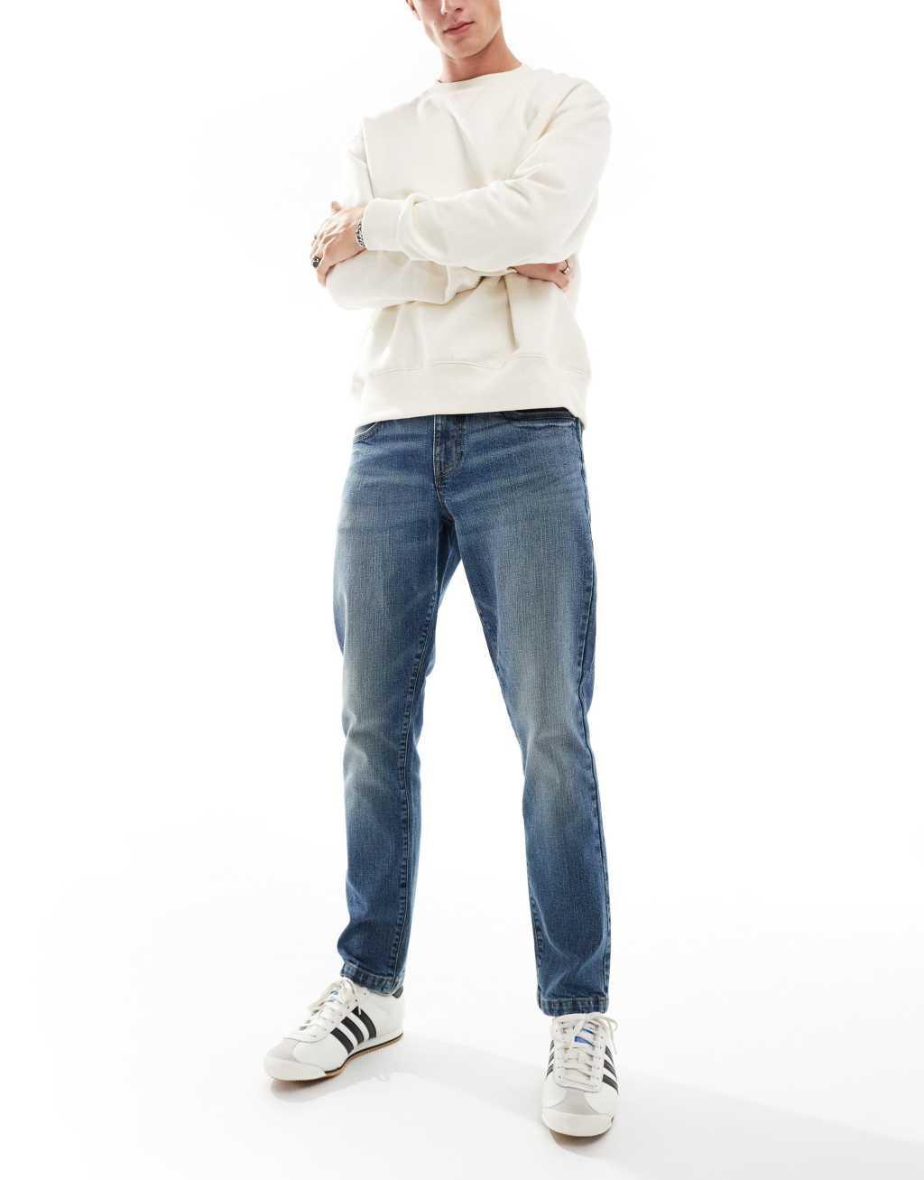ASOS DESIGN slim jeans in mid wash blue with tint Product Image