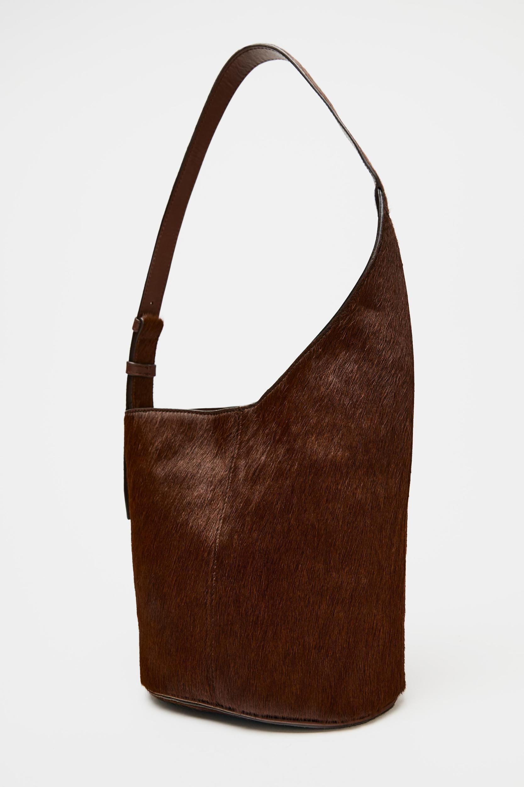 ASYMMETRIC FUR-TRIMMED LEATHER BUCKET BAG Product Image