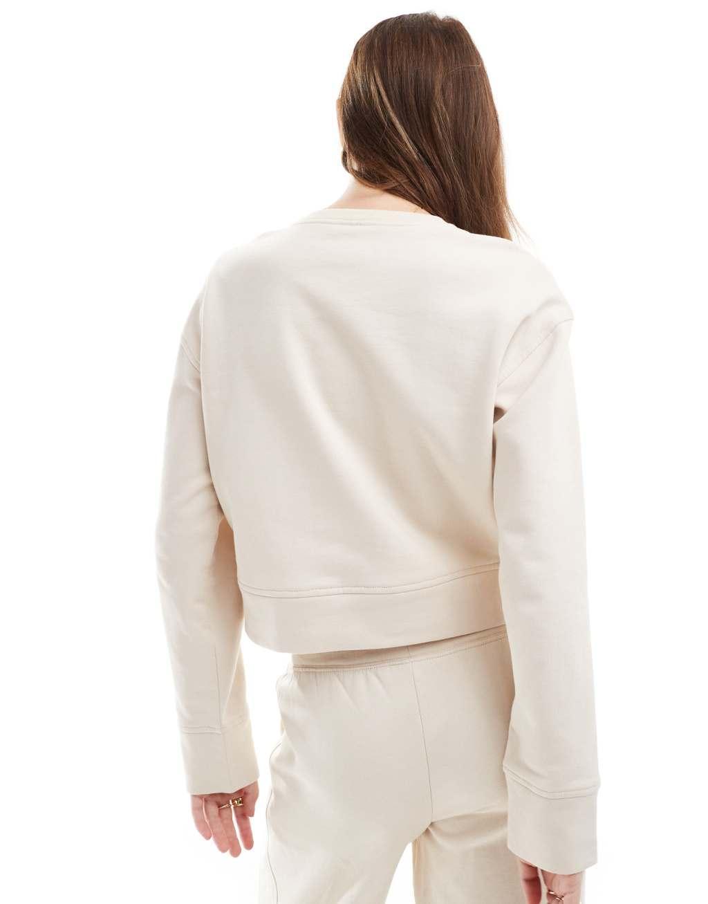 Calvin Klein Tonal Logo lounge crew neck sweatshirt in cream Product Image