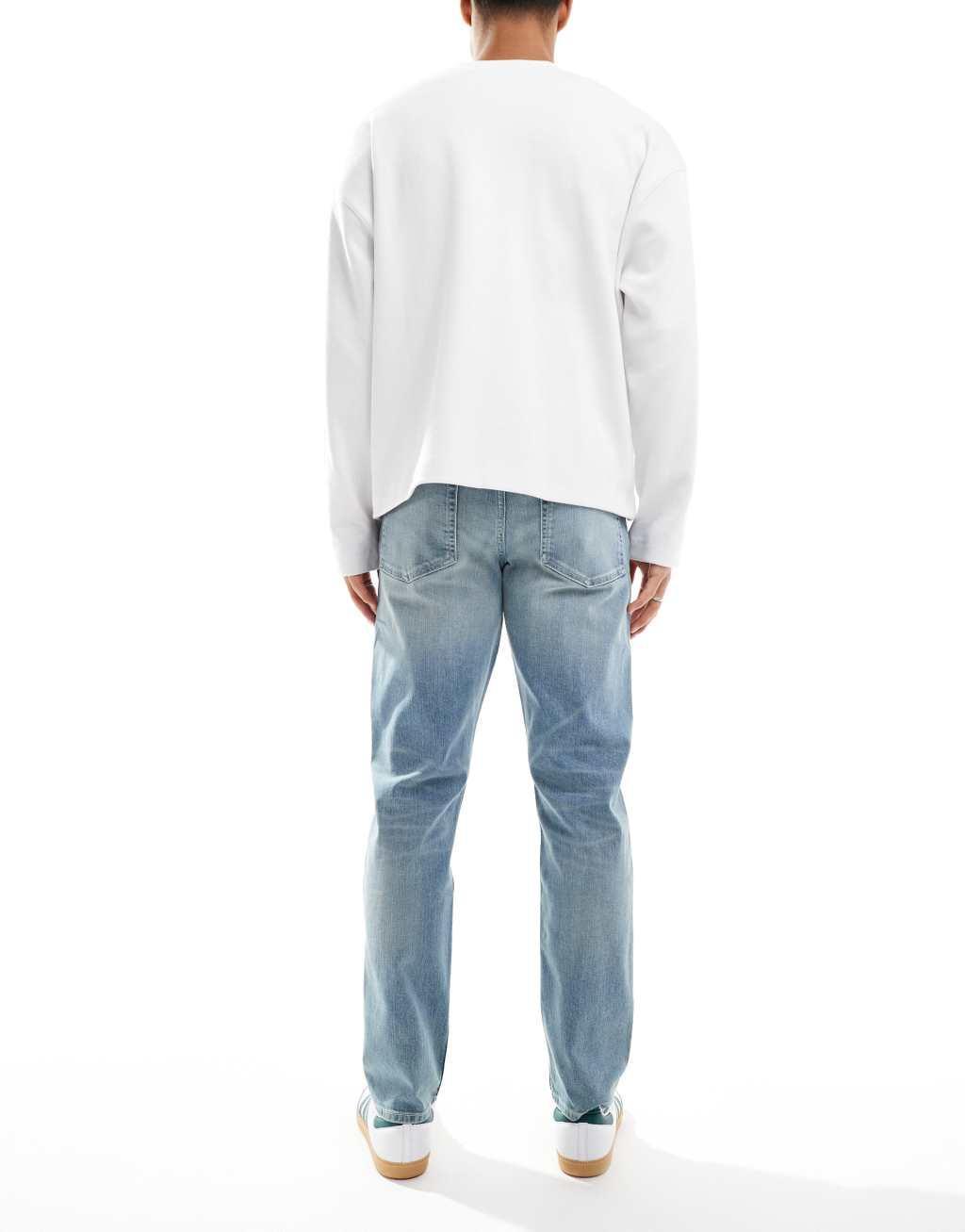 ASOS DESIGN slim jeans with tint in light wash blue Product Image