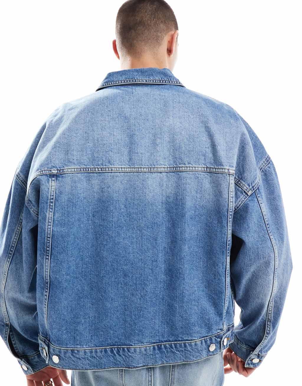 ASOS DESIGN oversized trucker jacket in mid wash blue Product Image