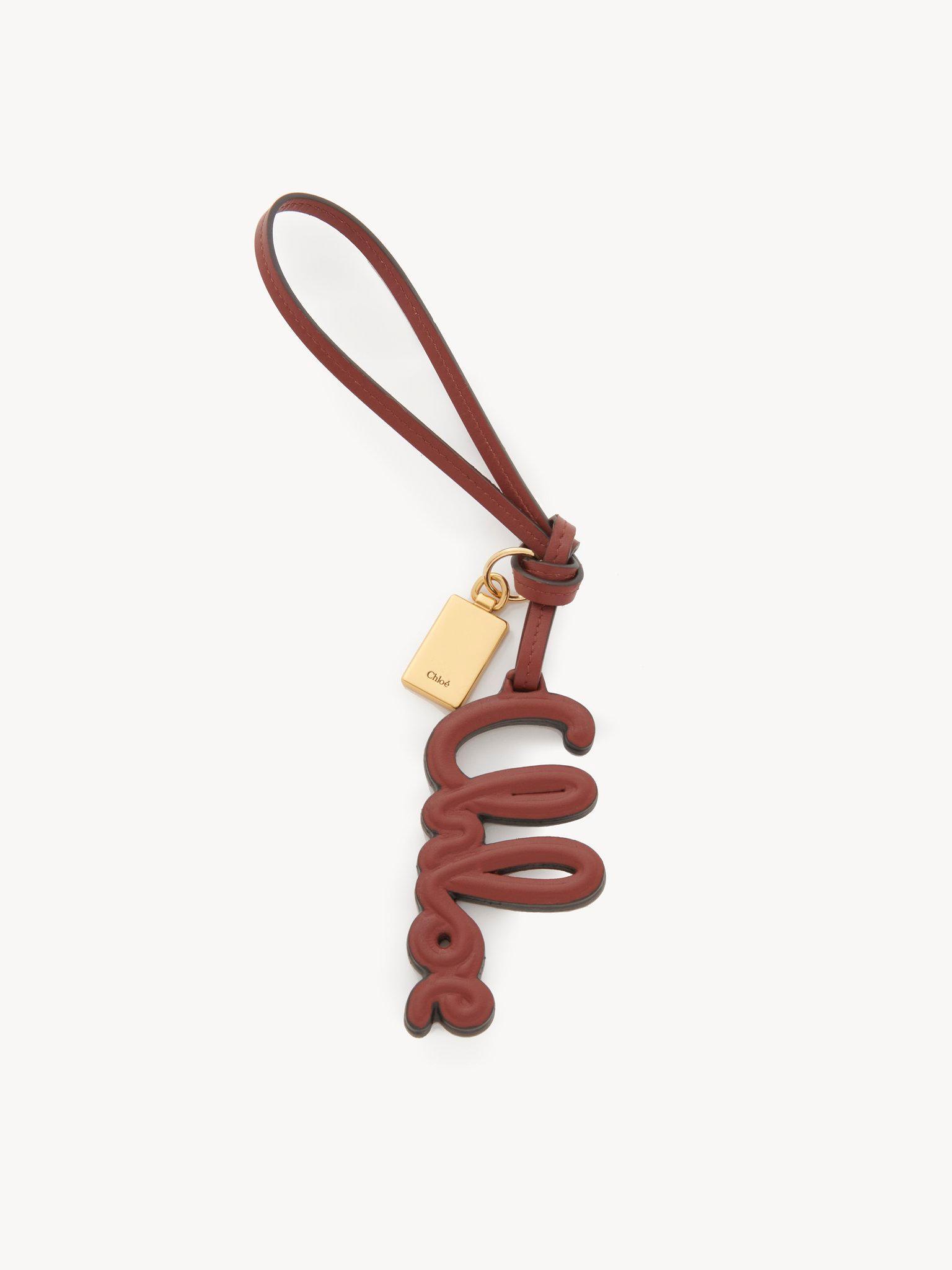 Logo bag charm in shiny leather Product Image