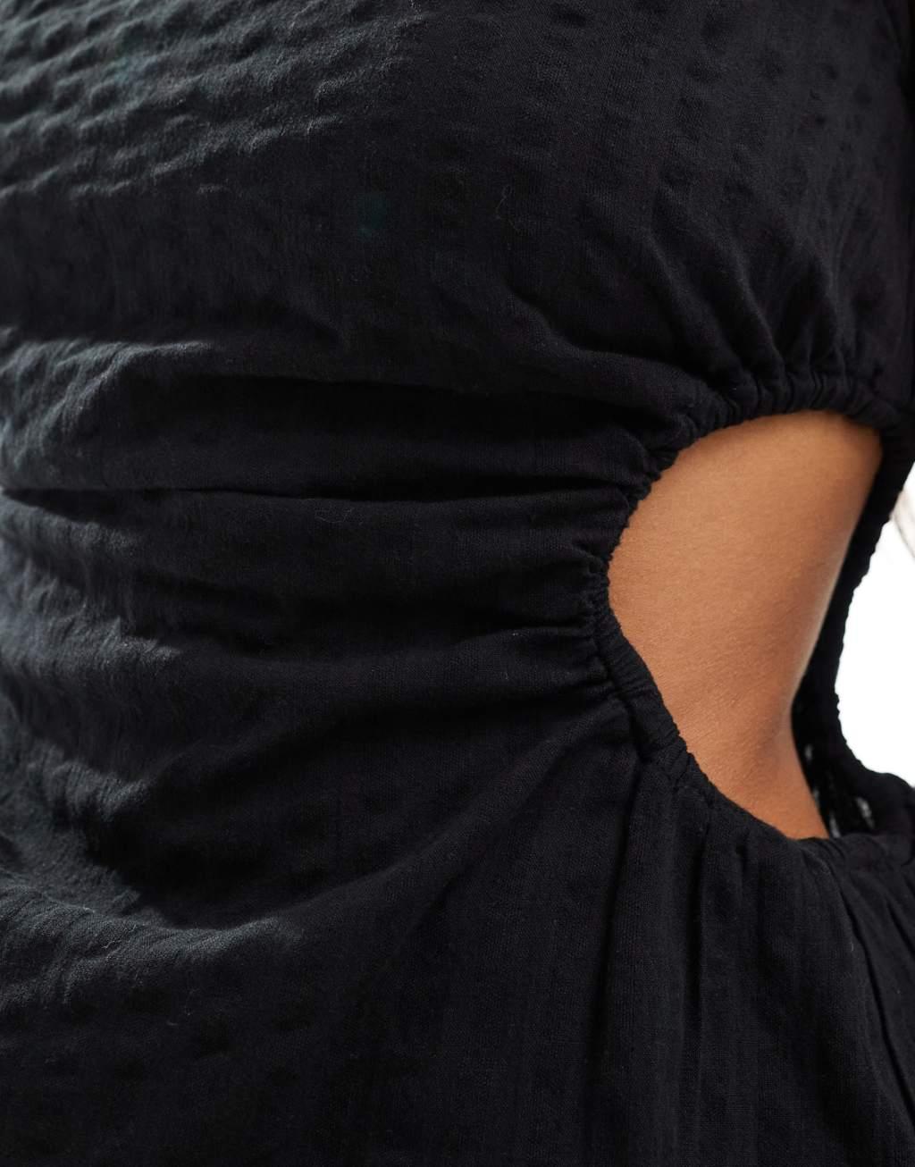 Monki sleeveless mini seersucker dress with ruched sides and cut out detail in black Product Image