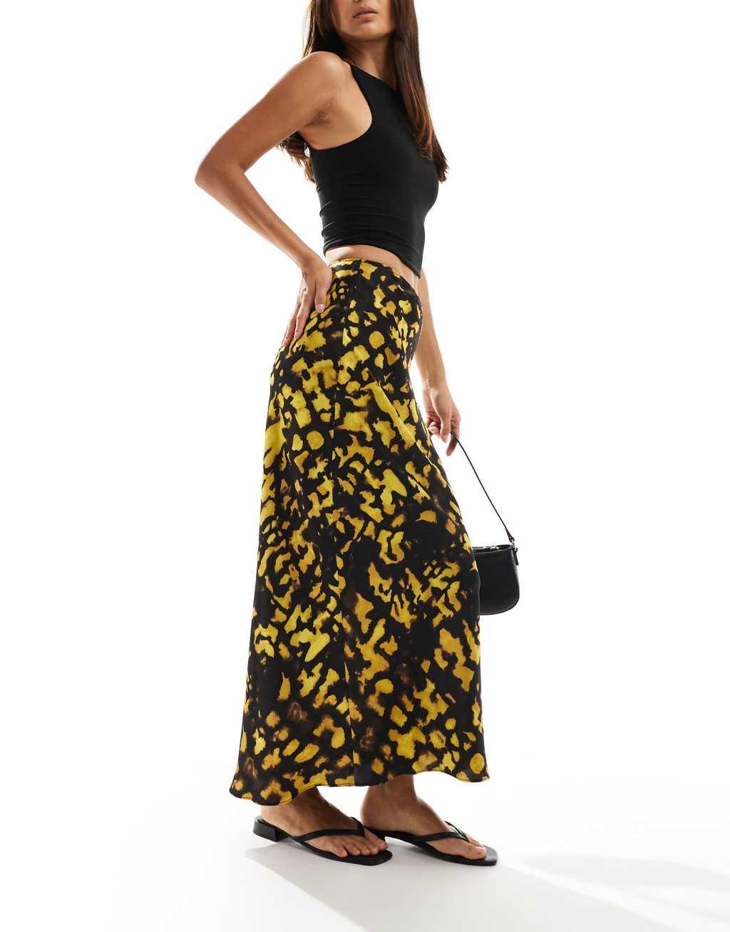 ASOS DESIGN satin bias cut midi skirt in yellow and black splotch print Product Image