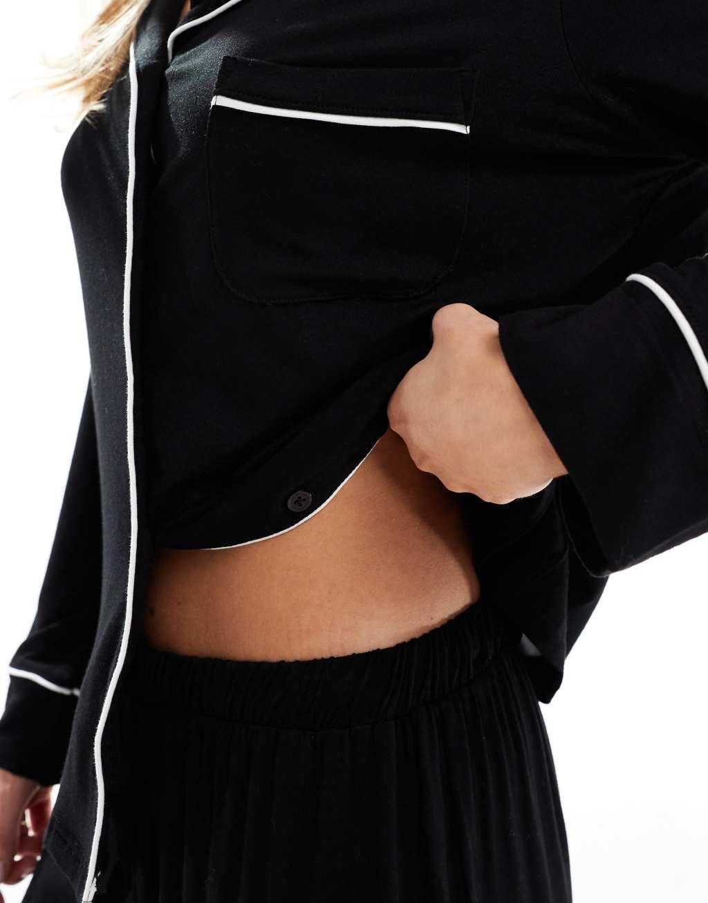ASOS DESIGN Petite super soft long sleeve shirt & pants pajama set with contrast piping in black Product Image