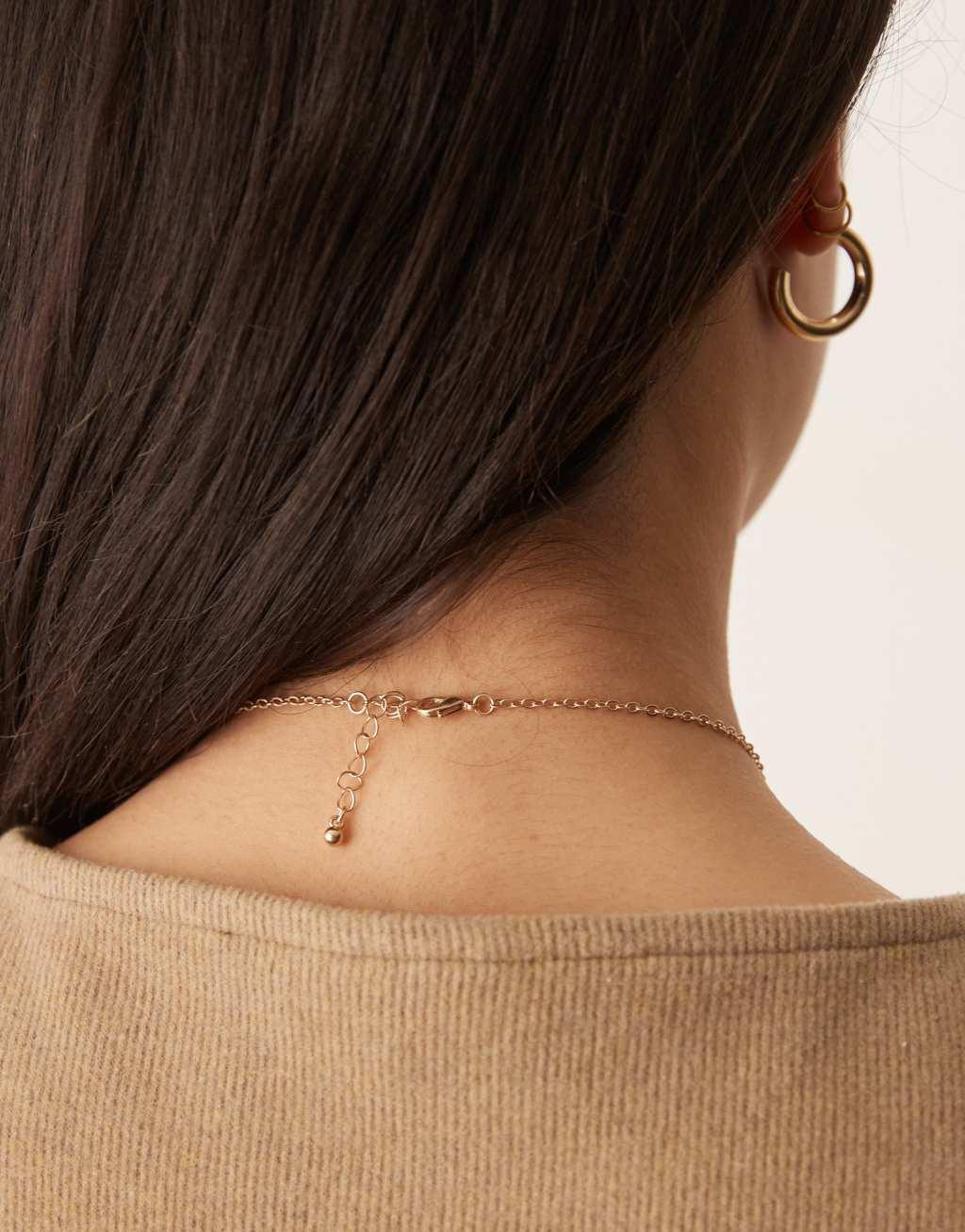 ASOS DESIGN lariat necklace with leaf detail in worn gold  Product Image