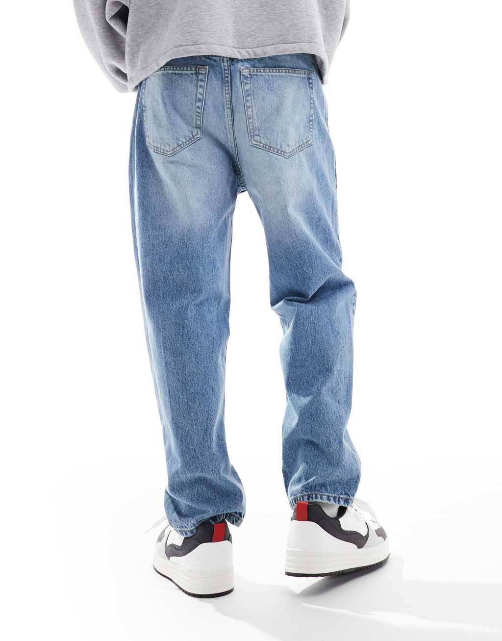 Bershka loose fit jeans in mid wash blue Product Image