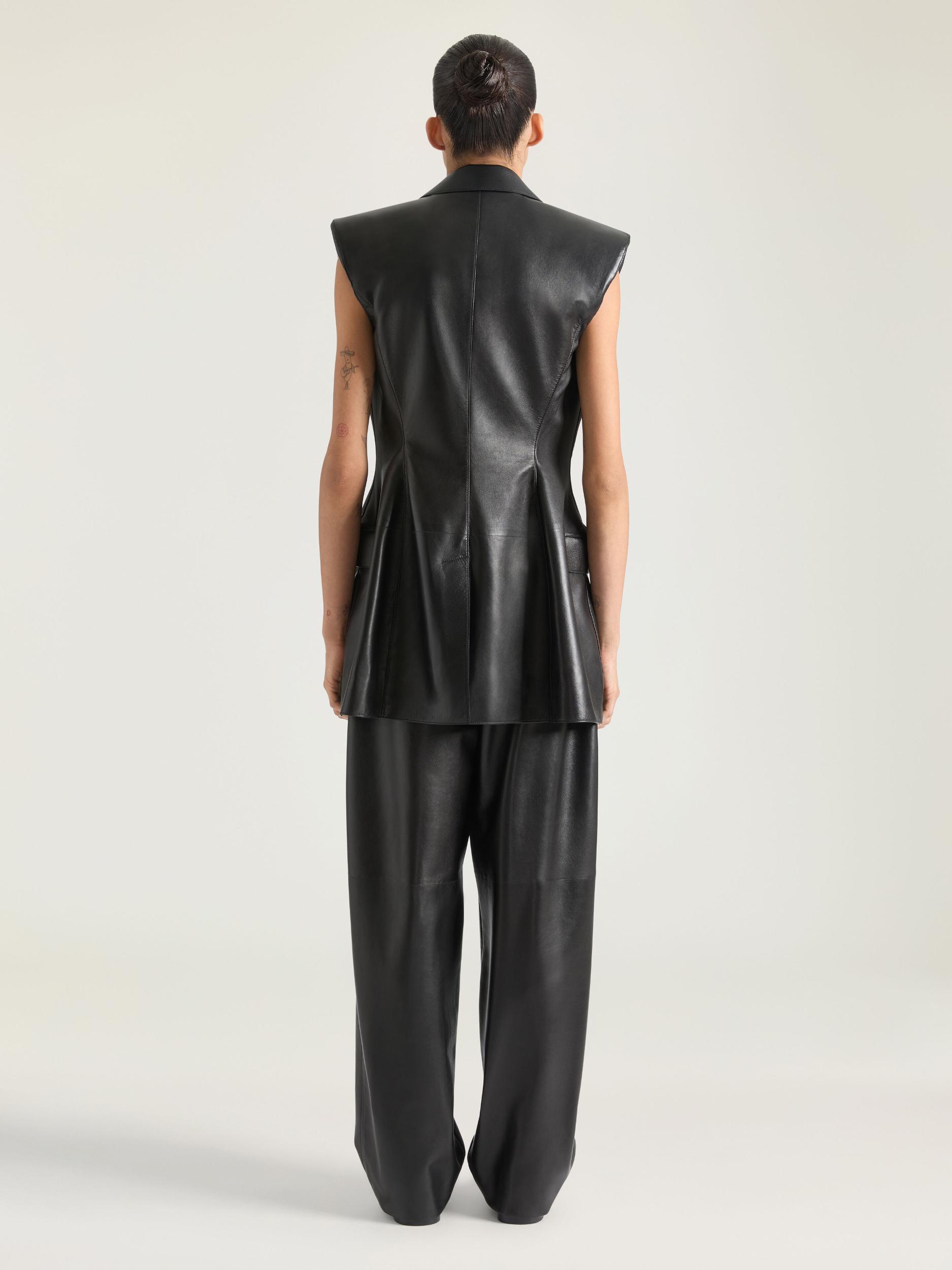 Double-breasted sleeveless jacket in leather Product Image