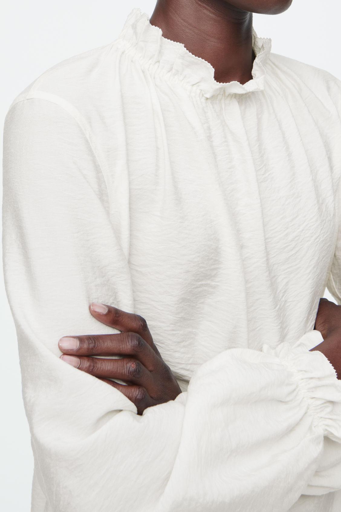 RUFFLED HIGH-NECK BLOUSE Product Image