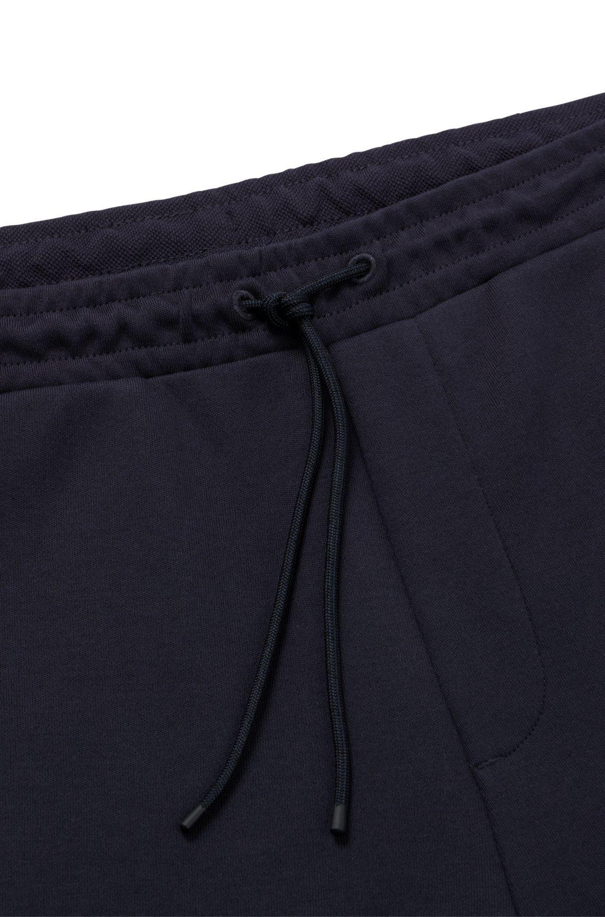 Cotton tracksuit bottoms with curved logo Product Image