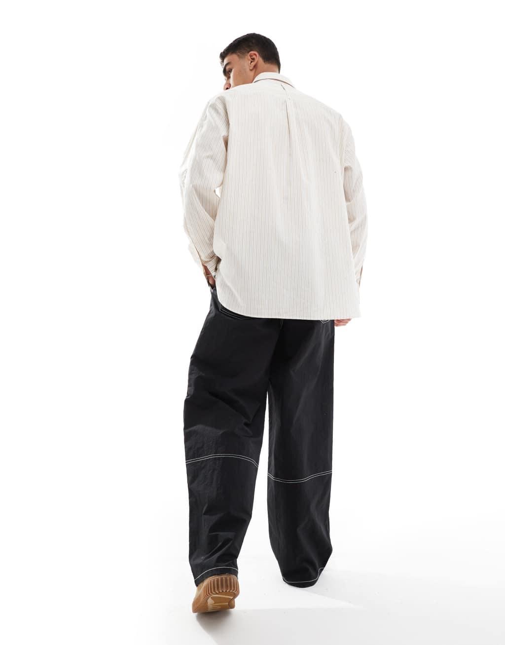 ASOS DESIGN baggy pants in black nylon with contrast stitch Product Image