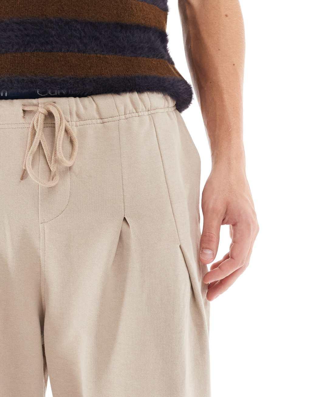 ASOS DESIGN wide leg pleated sweatpants in beige Product Image
