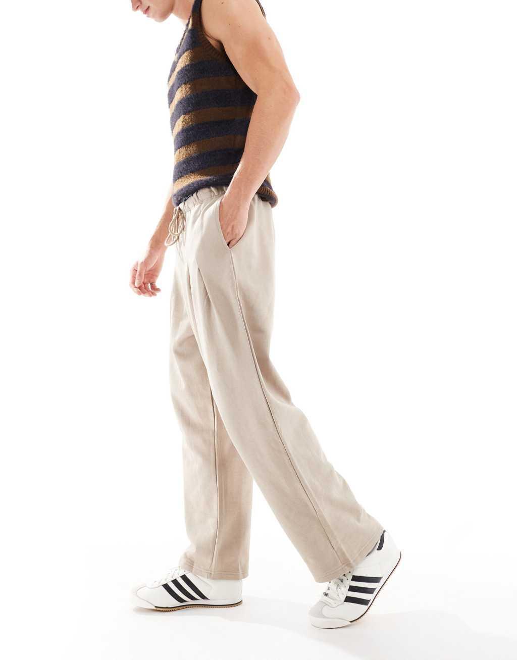 ASOS DESIGN wide leg pleated sweatpants in beige Product Image