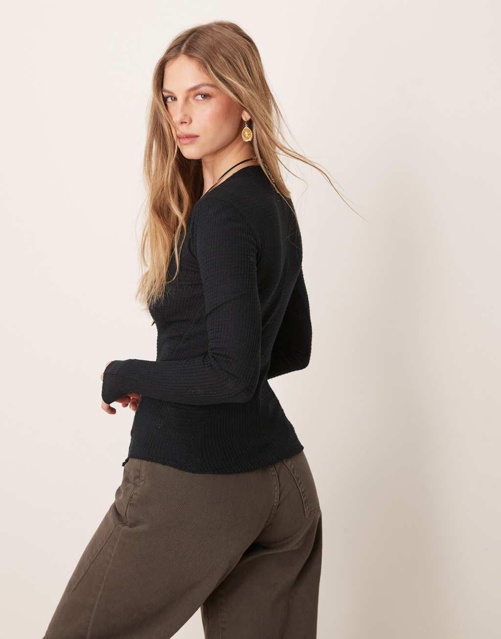 Free People going places snap detail cardigan in black Product Image